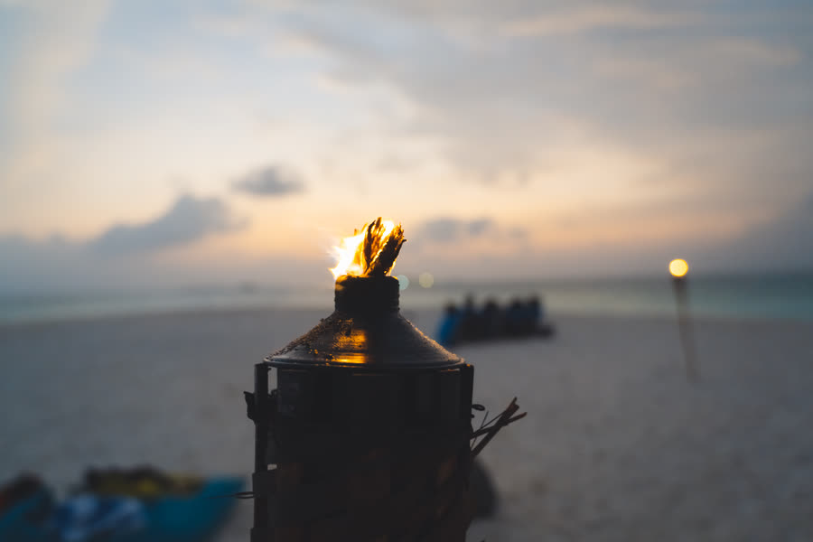 The torches go on as the sun drops